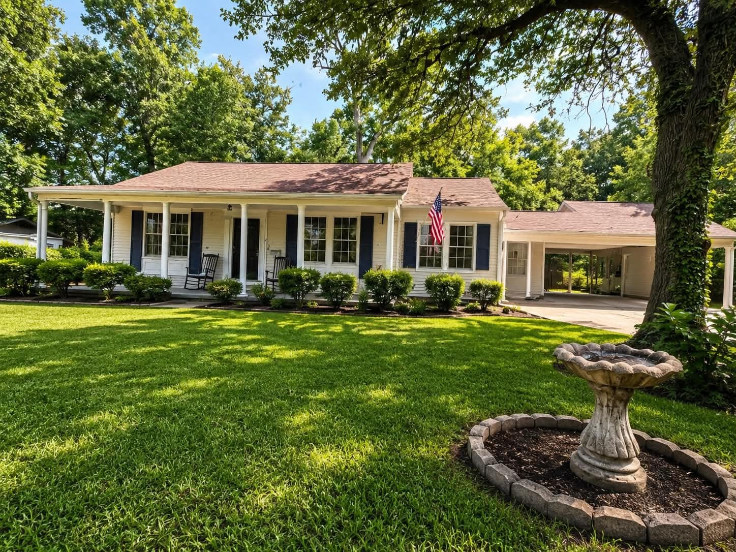 Elevate Haven house exterior with a welcoming front porch, lawn, and mature trees